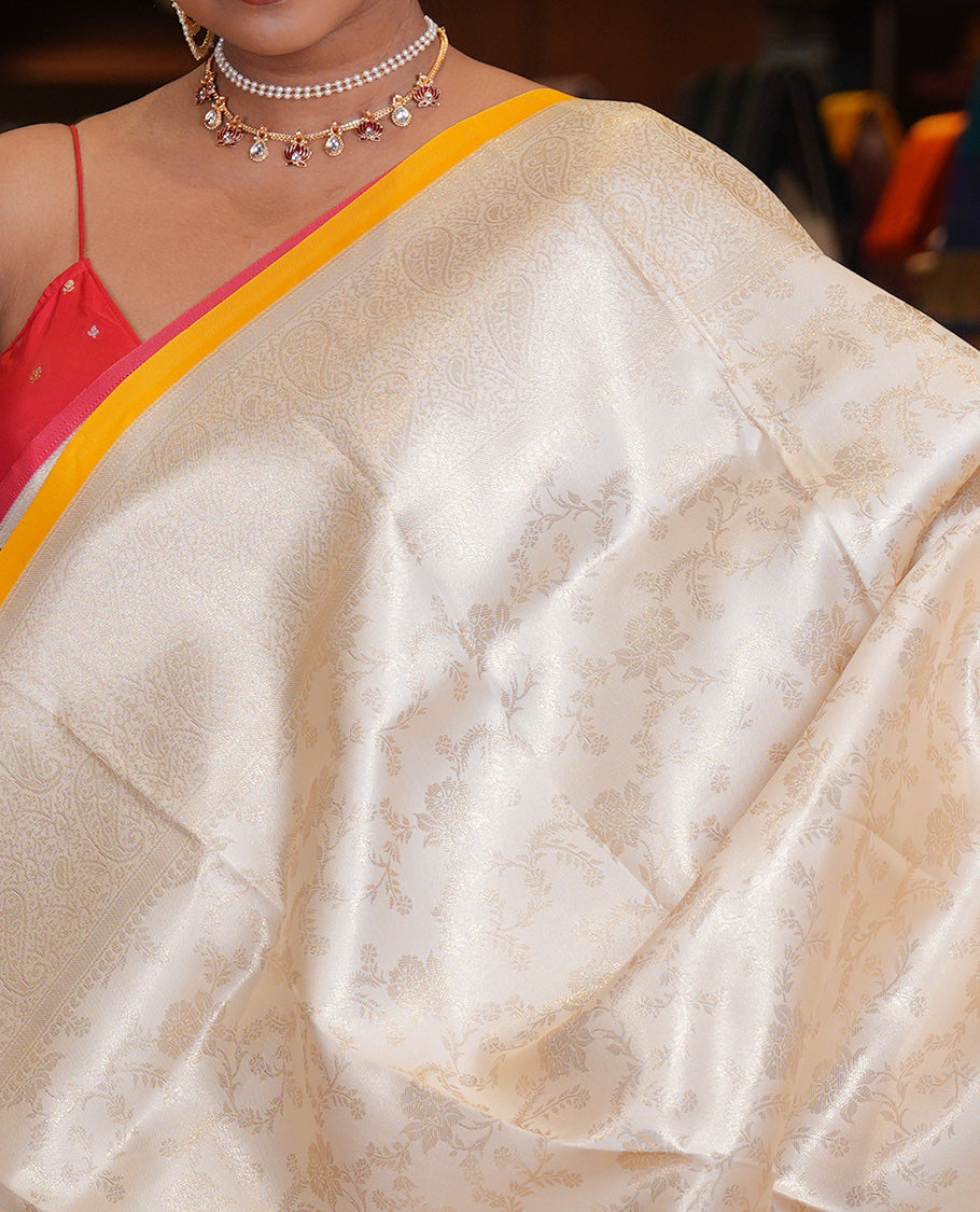 Off-White-Yellow Semi-Silk Saree, Adorned with Floral Jacquard Design, a Zari Paisley Border, and a Contrast Blouse