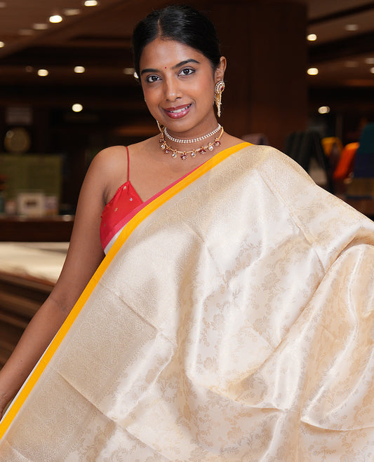 Off-White-Yellow Semi-Silk Saree, Adorned with Floral Jacquard Design, a Zari Paisley Border, and a Contrast Blouse