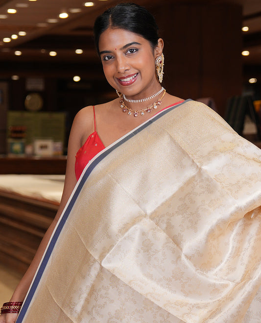 Off-White-Navy Semi-Silk Saree, Adorned with Floral Jacquard Design, a Zari Paisley Border, and a Contrast Blouse