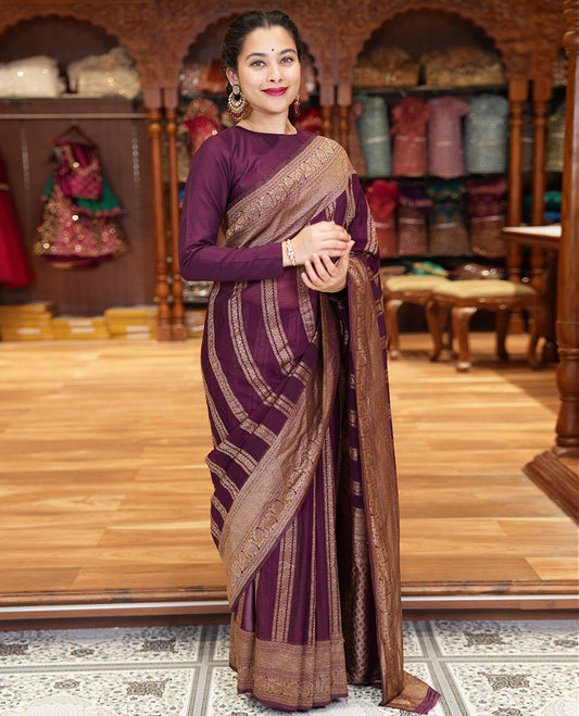 Wine Fancy Khaddi Georgette Adorned with Geometric Patterns in Zari, Subtly Woven Border Steeped with Traditional Designs, Richly Woven Pallu of Jaal Designs, and Paired with a Matching Blouse