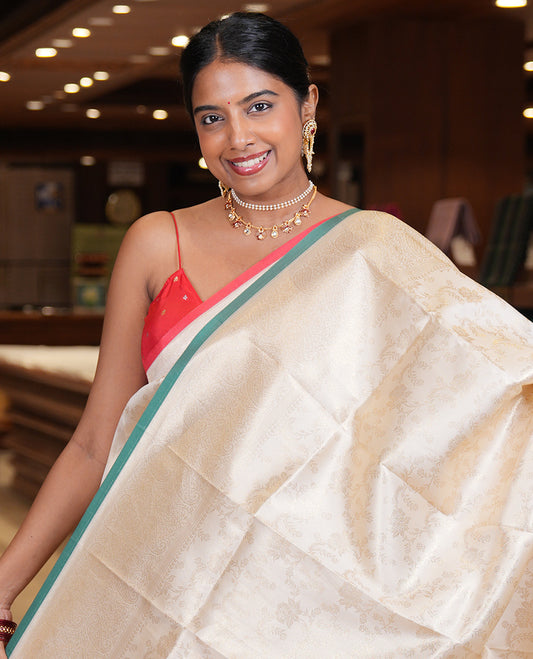 Off-White-Leaf Green Semi-Silk Saree, Adorned with Floral Jacquard Design, a Zari Paisley Border, and a Contrast Blouse
