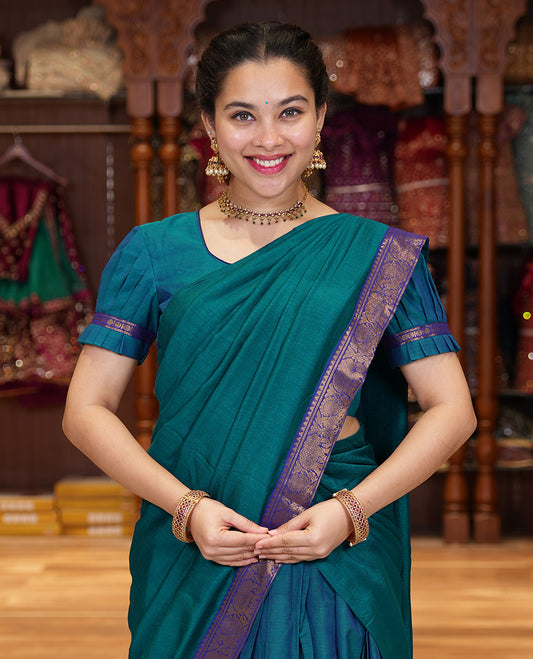 Blue Chettinad Cotton Half-Saree Featuring a Plain Skirt, Highlighted with a Contrast Peacock-Elephant Motifs Woven Rettai Pettu Zari Border, a Subtly Woven Matching Blouse, and a Vichitra Silk Contrast Traditional Zari-Bordered Dhavani