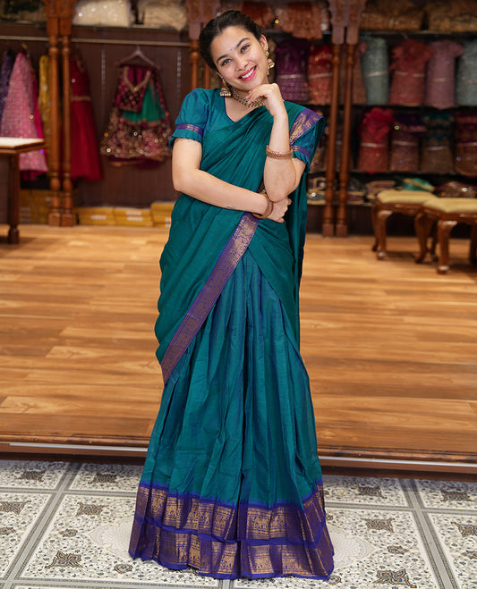 Blue Chettinad Cotton Half-Saree Featuring a Plain Skirt, Highlighted with a Contrast Peacock-Elephant Motifs Woven Rettai Pettu Zari Border, a Subtly Woven Matching Blouse, and a Vichitra Silk Contrast Traditional Zari-Bordered Dhavani
