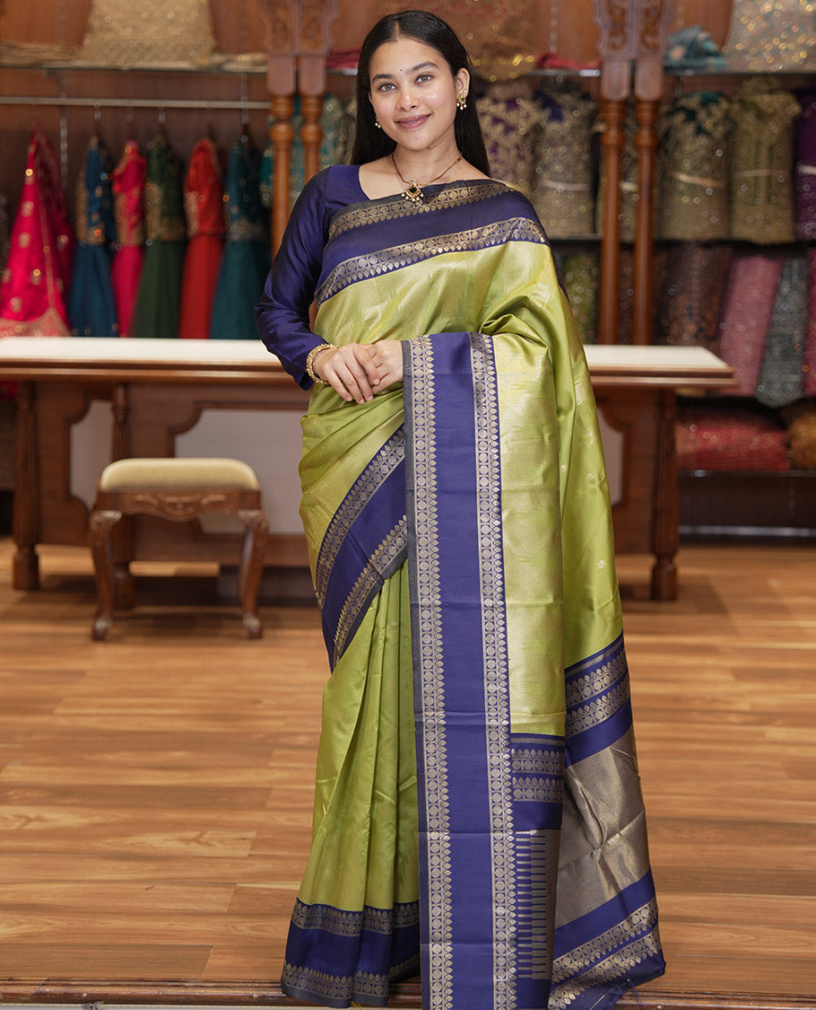 Pista Green Litchi Saree, Bedecked with Peacock Buttas , Contrast Temple Traditional Rettai Pettu Border, Pallu of Traditional , and Contrast Blouse