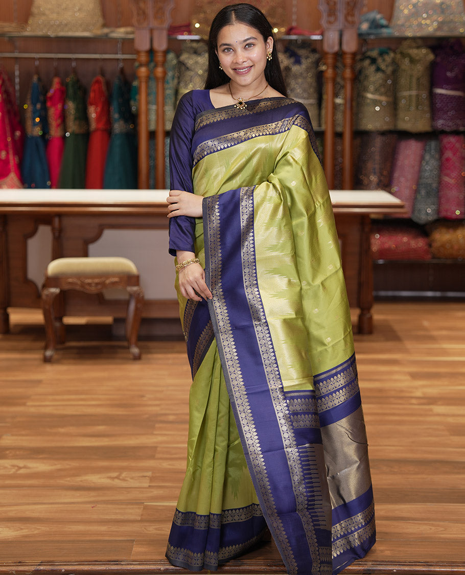 Pista Green Litchi Saree, Bedecked with Peacock Buttas , Contrast Temple Traditional Rettai Pettu Border, Pallu of Traditional , and Contrast Blouse
