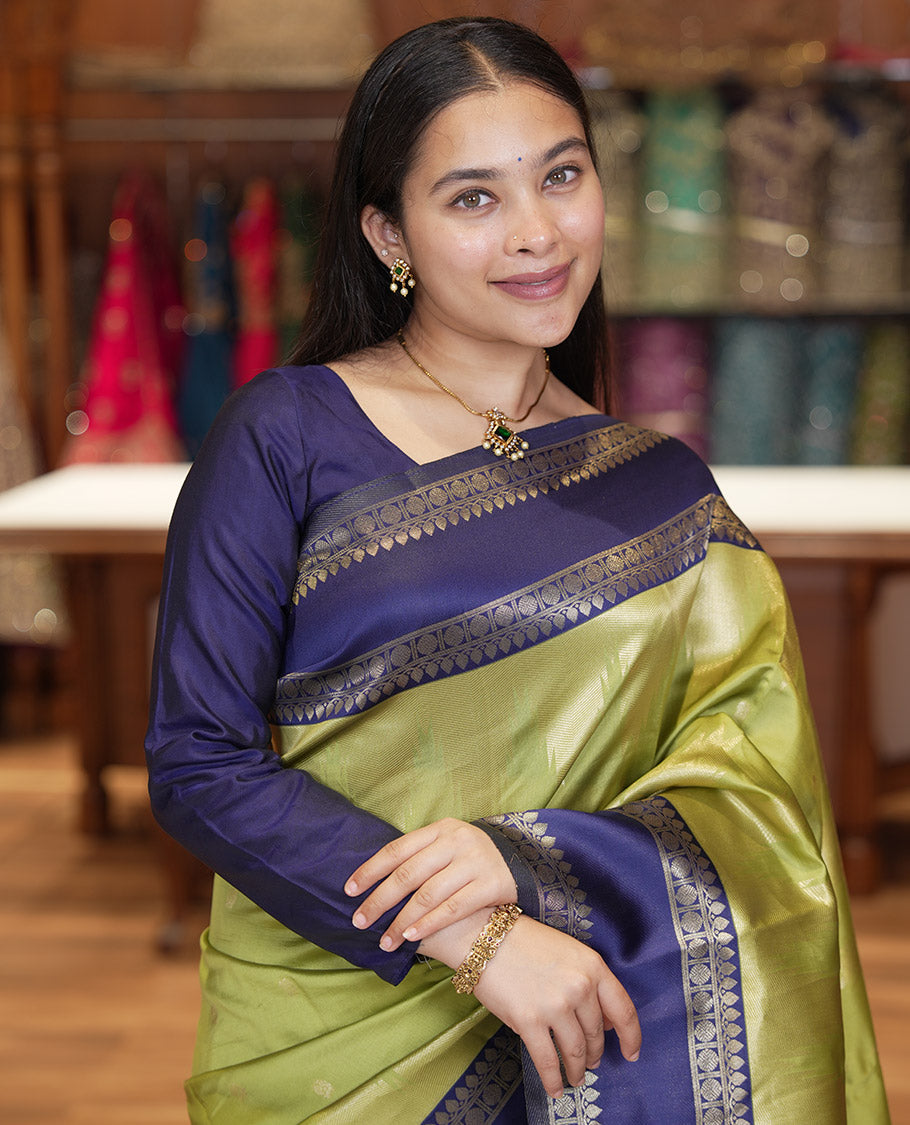 Pista Green Litchi Saree, Bedecked with Peacock Buttas , Contrast Temple Traditional Rettai Pettu Border, Pallu of Traditional , and Contrast Blouse
