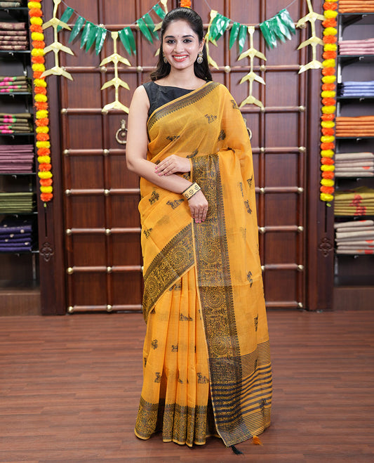 Yellow Chanderi Cotton Saree Delicately Woven with Warli Motifs All Over Its Body, Featuring a Subtly Sparkled Border Depicting Warli Village Motifs, Subtly Striped Pallu, and Paired with a Matching Blouse