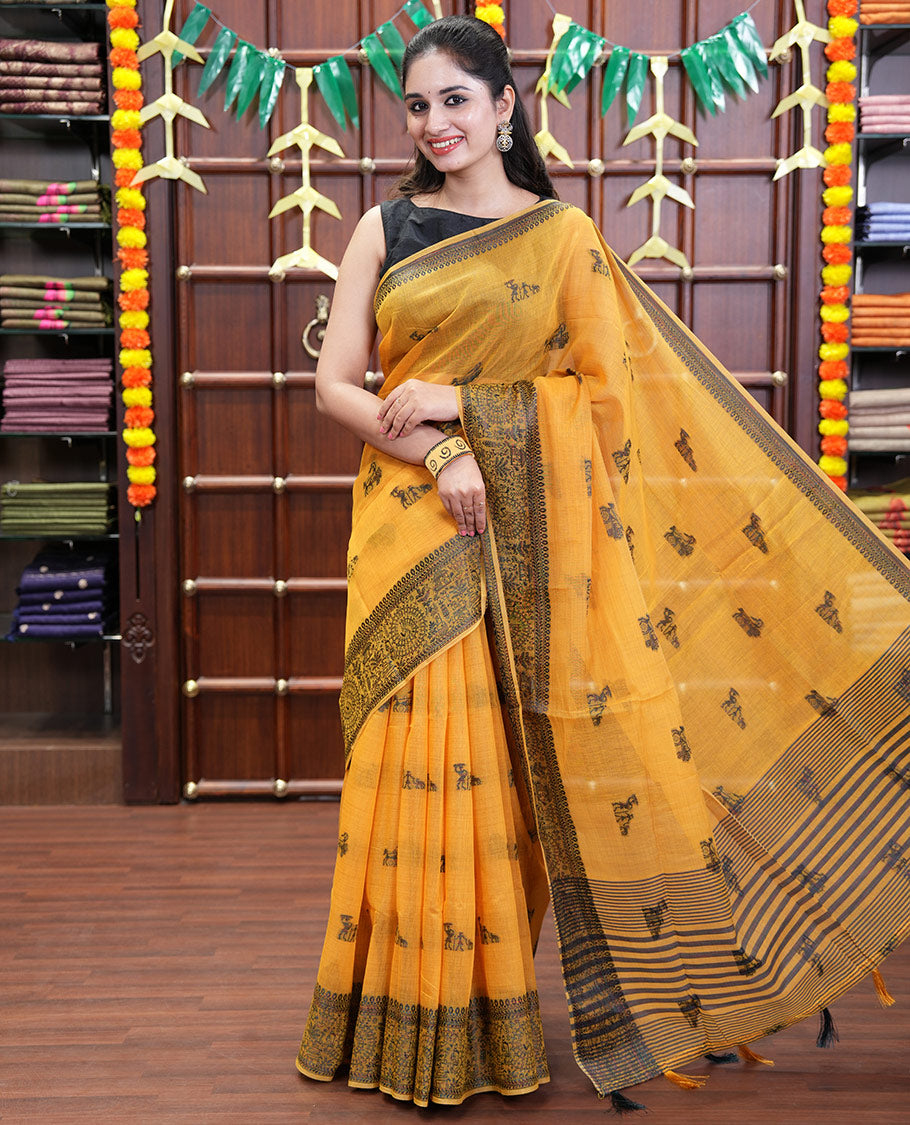 Yellow Chanderi Cotton Saree Delicately Woven with Warli Motifs All Over Its Body, Featuring a Subtly Sparkled Border Depicting Warli Village Motifs, Subtly Striped Pallu, and Paired with a Matching Blouse