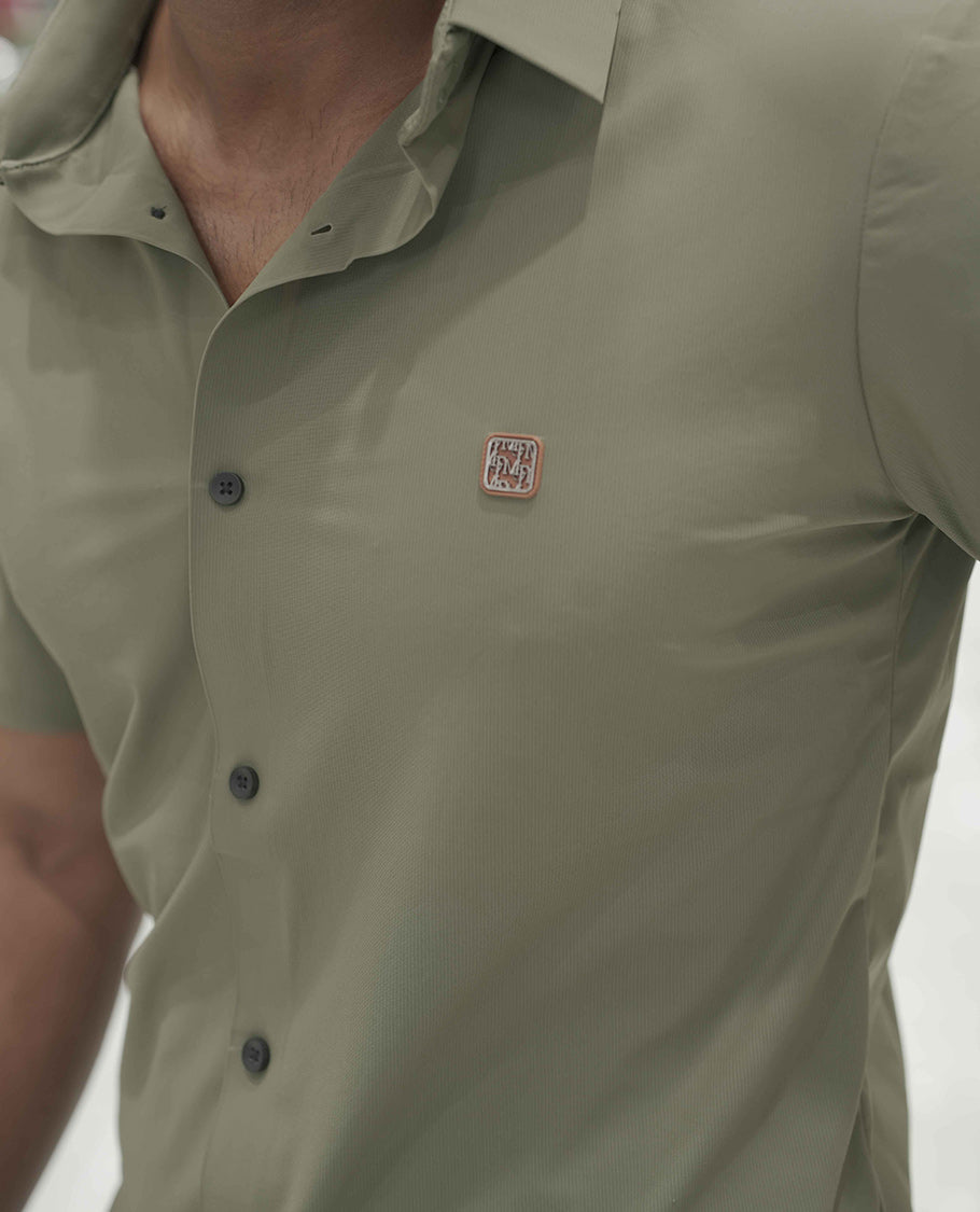 Olive Green Plain Poly Lycra Blended Casual Shirt, Comes with a Spread Collar, Stitchless Half-Sleeves, Slim Fit, and Regular Length