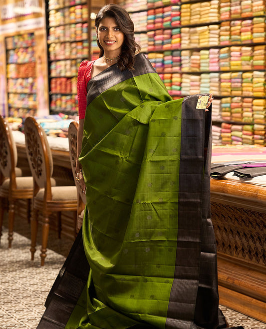 Green buttas kancheepuram silk saree with self border of thilakam mokku, muthu, banaras design & zari design pallu