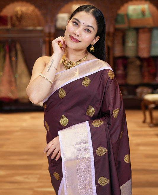 Brown Kanchipuram Budget Silk Saree, Embellished with Zari Buttas All Over Its Body, Complemented by a Contrast Traditional Zari Design Border, Masterfully Woven Pallu of Jaal Designs, and Paired with a Matching Blouse