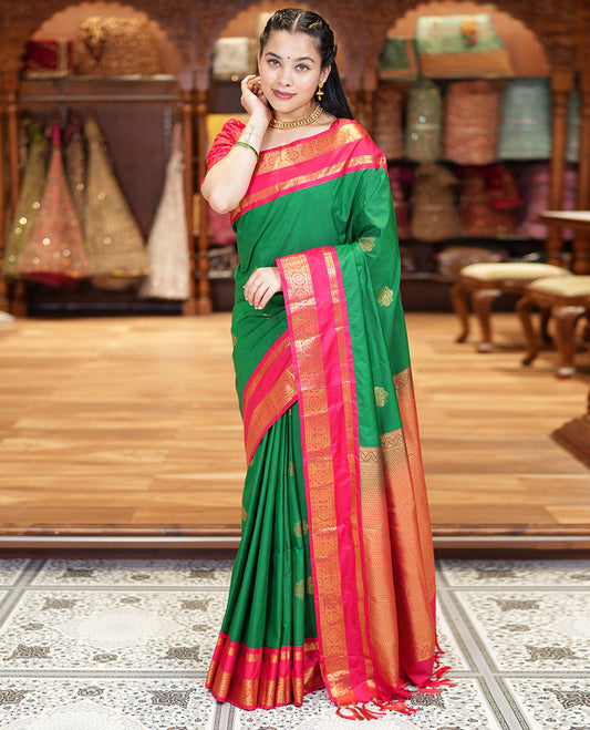 Green Kanchipuram Budget Silk Saree, Detailed with Zari Buttas All Over Its Body, Complemented by a Contrast Traditional Zari Rettai Pettu Border of Chakram Designs, Gracefully Embellished Pallu, and Paired with a Contrast Blouse