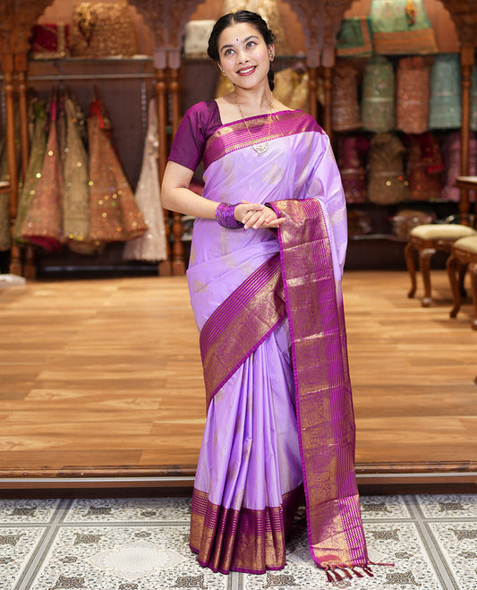 Lavender Kanchipuram Budget Silk Saree, Accentuated with Zari Buttas and Zari Stripes All Over Its Body, Complemented by a Contrast Traditional Zari Design Border, Zari-Rich Jaal Pallu, and Paired with a Contrast Blouse