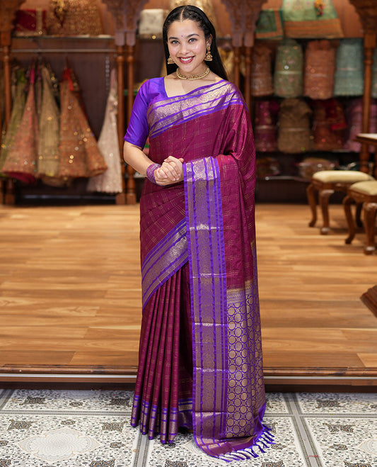 Maroon Kanchipuram Budget Silk Saree, Ornamented with Plus-Sized Butta Enclosed Checks All Over Its Body, Complemented by a Contrast Traditional Zari Border of Round Peacock Designs, Pallu Steeped with Circle Motifs, and Paired with a Contrast Blouse