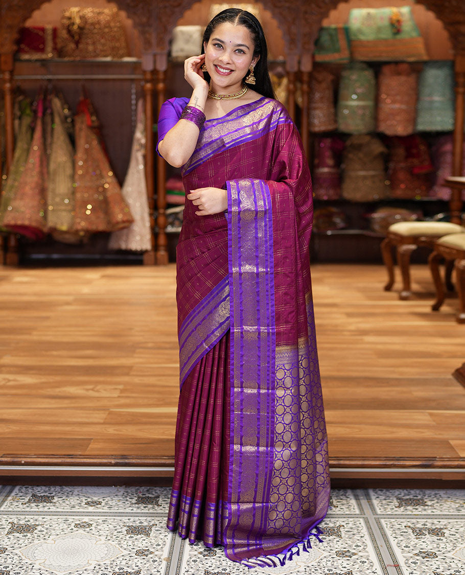 Maroon Kanchipuram Budget Silk Saree, Ornamented with Plus-Sized Butta Enclosed Checks All Over Its Body, Complemented by a Contrast Traditional Zari Border of Round Peacock Designs, Pallu Steeped with Circle Motifs, and Paired with a Contrast Blouse