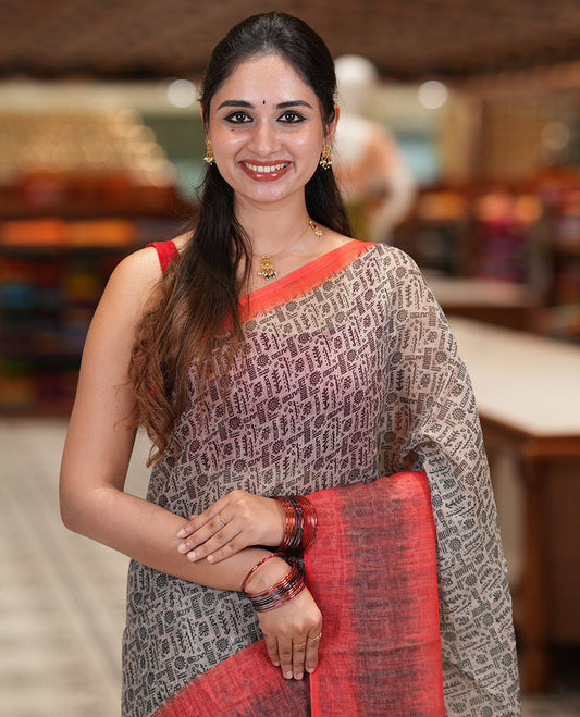 Chikku-Orange Linen Cotton Saree, Ornamented with Intricate Print, a Contrast Ikat Border, Printed Pallu, and Contrast Blouse