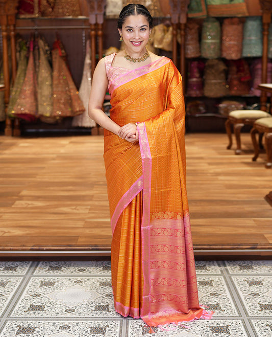 Orange Kanchipuram Budget Silk Saree, Gleamed Up with Zari Checks All Over Its Body, Complemented by a Contrast Floral Creeper Design Zari Border, Pallu Steeped with Floral Designs, and Paired with a Contrast Blouse