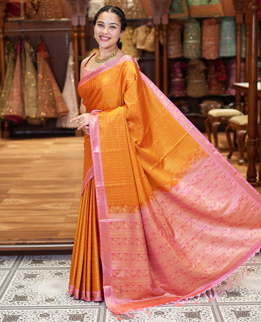 Orange Kanchipuram Budget Silk Saree, Gleamed Up with Zari Checks All Over Its Body, Complemented by a Contrast Floral Creeper Design Zari Border, Pallu Steeped with Floral Designs, and Paired with a Contrast Blouse