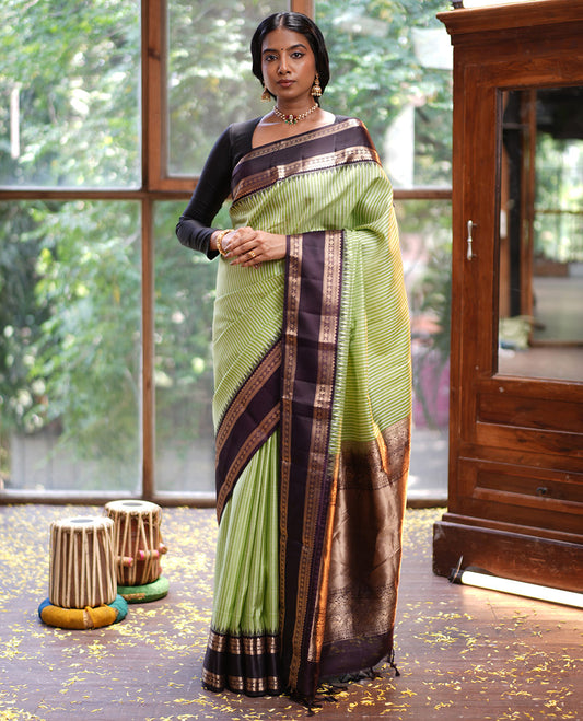 Green Vasundhara Silk Saree, Adorned with Kasa-Kasa-Style Checks, Complemented by a Contrast Rettai Pettu Border of Thazampoo Rekku, Salngai, Banaras, Kathir, Kamalam, and Star Designs, Gleaming Zari-Decked-Up Pallu and Paired with a Contrast Blouse