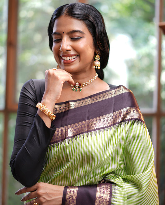 Green Vasundhara Silk Saree, Adorned with Kasa-Kasa-Style Checks, Complemented by a Contrast Rettai Pettu Border of Thazampoo Rekku, Salngai, Banaras, Kathir, Kamalam, and Star Designs, Gleaming Zari-Decked-Up Pallu and Paired with a Contrast Blouse