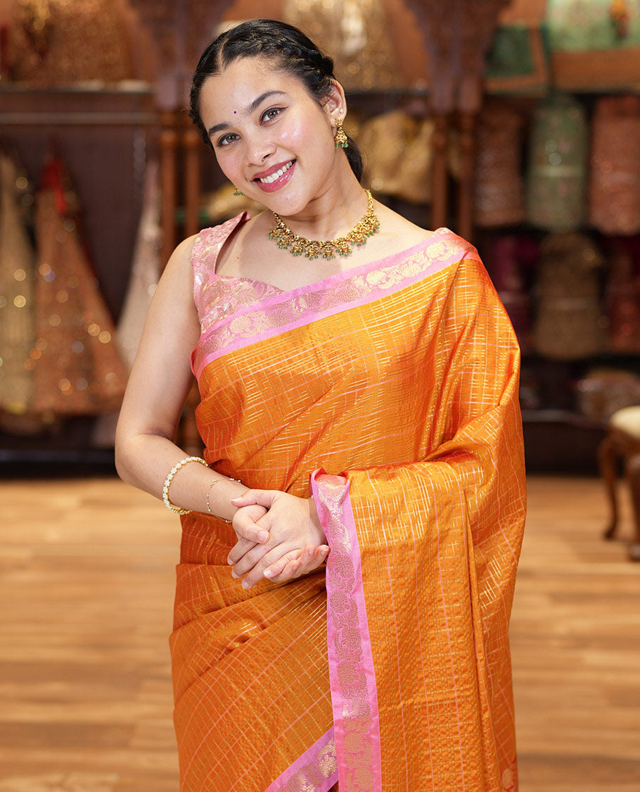 Orange Kanchipuram Budget Silk Saree, Gleamed Up with Zari Checks All Over Its Body, Complemented by a Contrast Floral Creeper Design Zari Border, Pallu Steeped with Floral Designs, and Paired with a Contrast Blouse