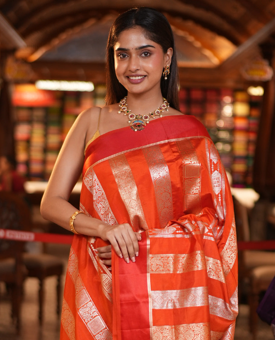 Orange Dupion Silk Saree, Richly Features Vertically Woven Traditional Patterns in Zari, Complemented by Contrast Zari Satin Border, Rich Pallu, and Paired with a Matching Blouse