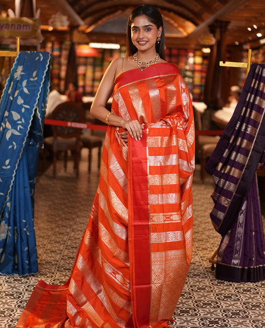 Orange Dupion Silk Saree, Richly Features Vertically Woven Traditional Patterns in Zari, Complemented by Contrast Zari Satin Border, Rich Pallu, and Paired with a Matching Blouse