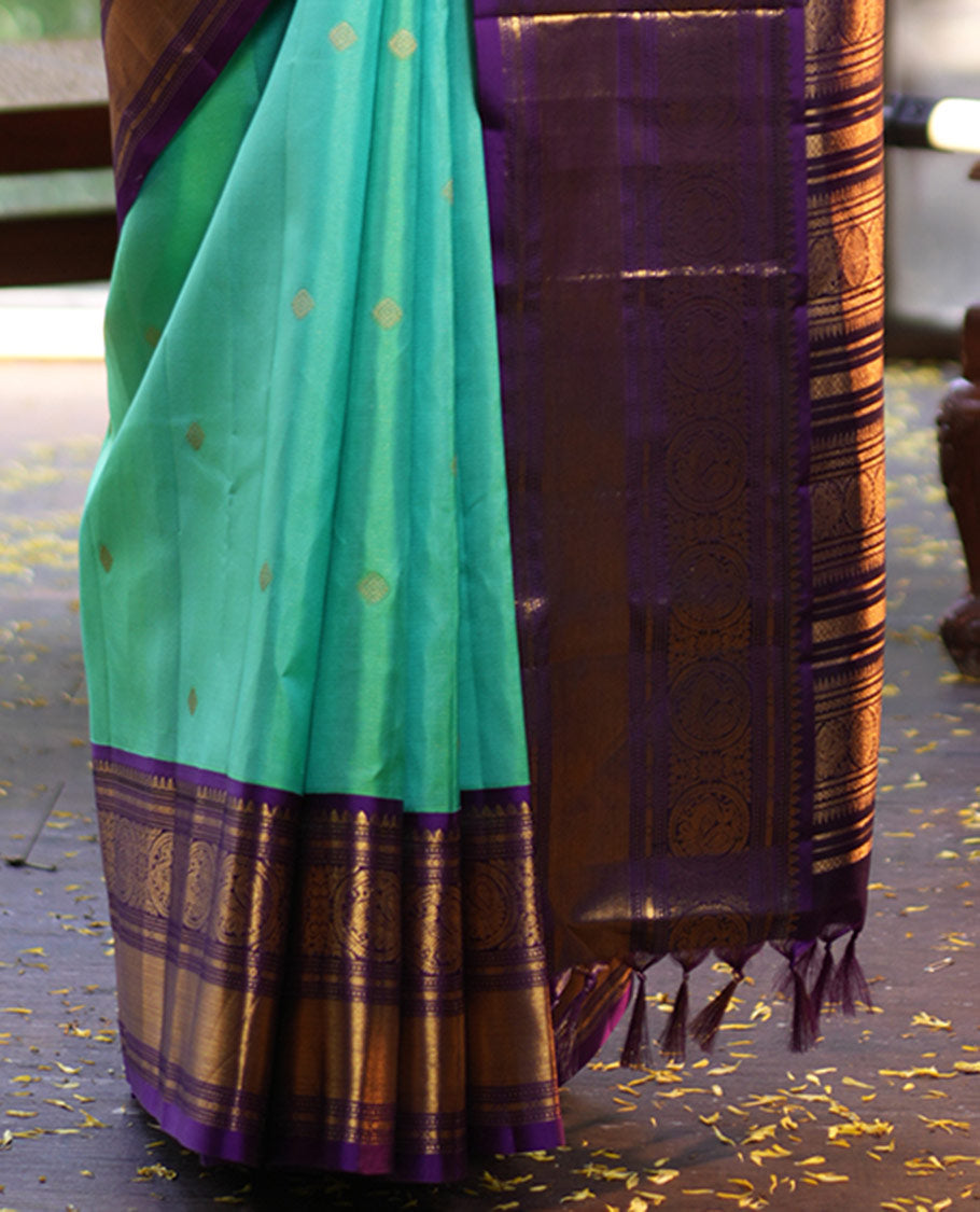 Rexona Green Vasundhara Silk Saree, Beautified with Sparse Stripes and Zari Buttas, Complemented by a Contrast Border of Thilakam, Banaras, Muthu, and Round Mayil Designs, Pallu Steeped with Traditional Designs, and Paired with a Contrast Blouse