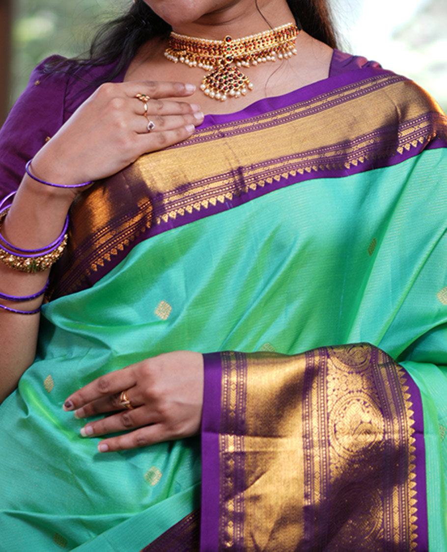 Rexona Green Vasundhara Silk Saree, Beautified with Sparse Stripes and Zari Buttas, Complemented by a Contrast Border of Thilakam, Banaras, Muthu, and Round Mayil Designs, Pallu Steeped with Traditional Designs, and Paired with a Contrast Blouse