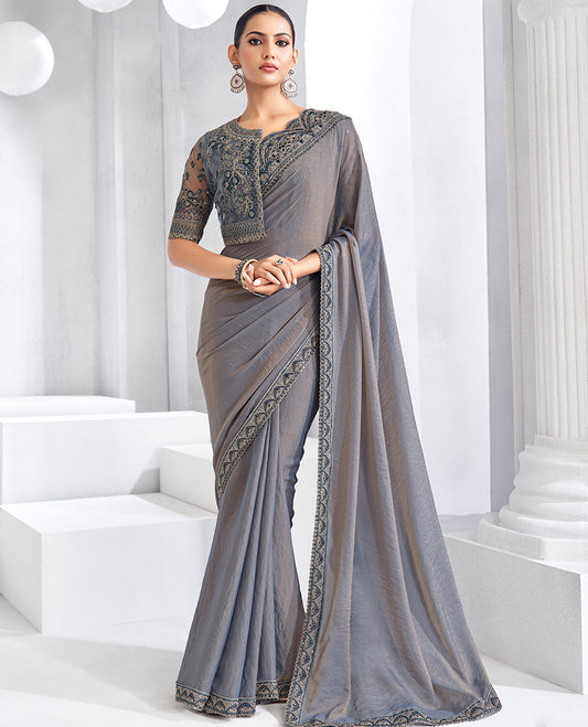 Grey plain designer saree, scallop embroidered border, self-pallu, and a heavy embroidered jacket blouse