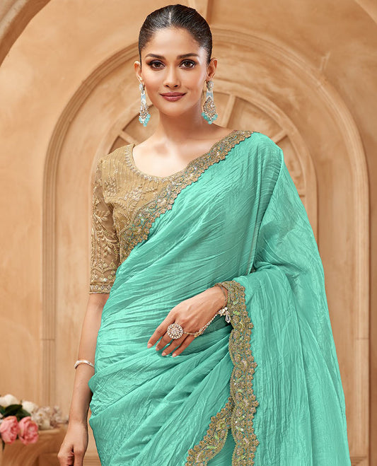 Turquoise crushed designer saree, scallop embroidered border, and contrast embroidered blouse