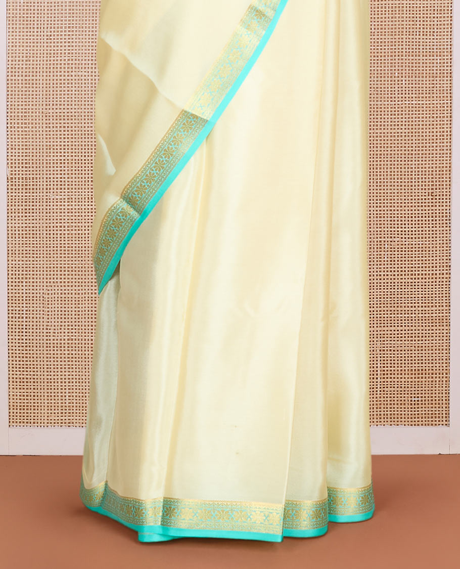 Pale yellow plain Mysore silk saree, contrast floral design zari border & pallu of zari stripes