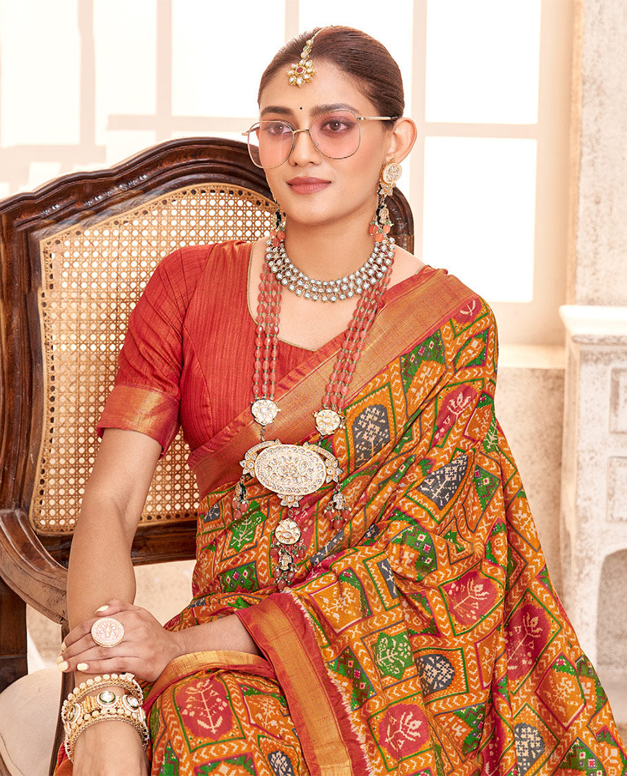 Orange Patola Fancy Raw Silk Designer Saree, Adorned with Intricate Design, a Bavanji Border, Intricately Designed Pallu, and a Contrast Blouse