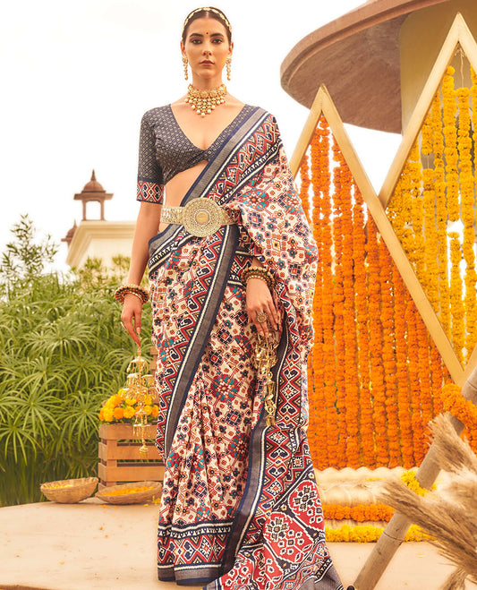 Multi-color intricate patola printed designer saree, contrast blue ikkat border, and floral design pallu