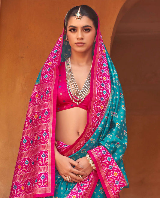Light Blue Ikat Patola Designer Saree, Decked Up with Floral Ikat Buttas, Complemented by a Contrast Ikat Border, Intricate Pallu, and a Contrast Blouse