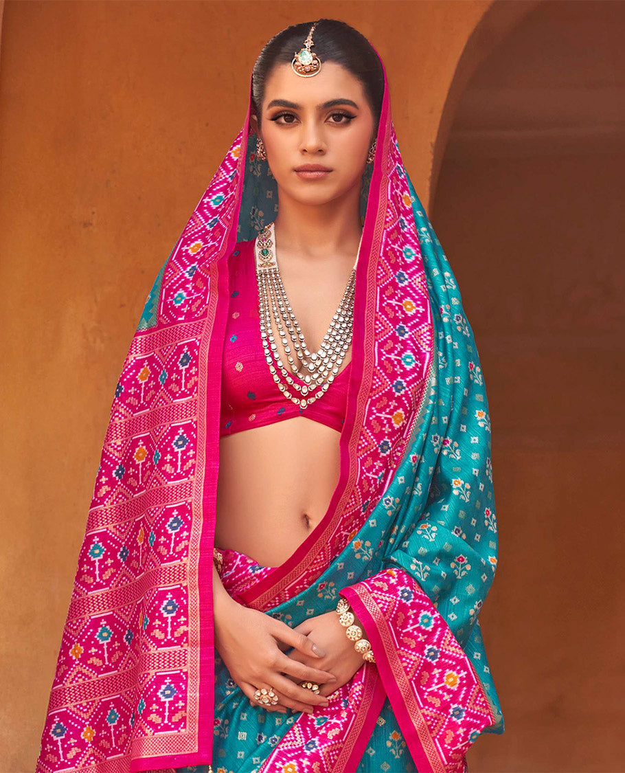 Light Blue Ikat Patola Designer Saree, Decked Up with Floral Ikat Buttas, Complemented by a Contrast Ikat Border, Intricate Pallu, and a Contrast Blouse