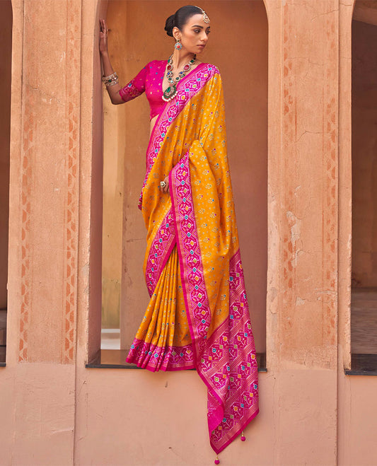 Orange Ikat Patola Designer Saree, Elevated with Floral Ikat Buttas, Complemented by a Contrast Ikat Border, Intricate Pallu, and a Contrast Blouse