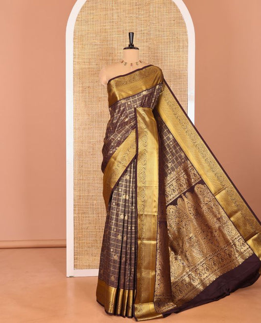 Brown Kanchipuram budget silk saree enriched with zari butta enclosed checks all over its body, complemented by zari traditional design border, Mughal-style intricate pallu, and paired with a Matching blouse