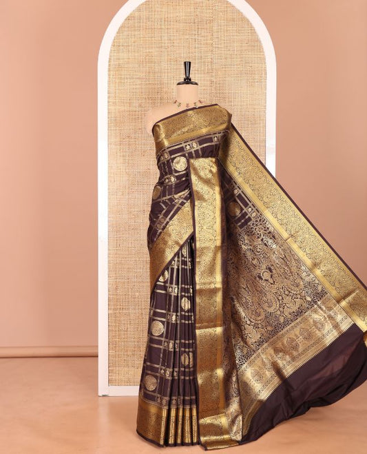 Brown Kanchipuram budget silk saree artfully woven with chakram zari butta enclosed checks all over its body, complemented by zari traditional design border, Mughal-style intricately woven pallu, and paired with a Matching blouse