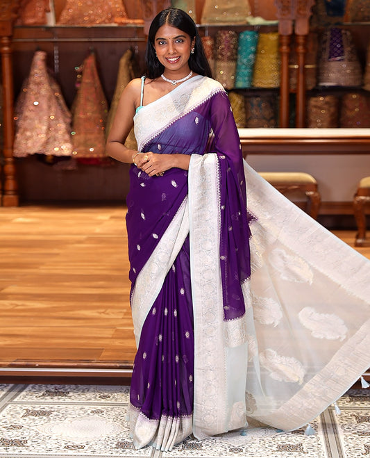 Purple Banaras Fancy Georgette Saree, Adorned with Zari Buttas All Over Its Body, Complemented by a Contrast Floral Creeper Zari Border, Pallu Features Paisley Designs, and Paired with a Contrast Blouse
