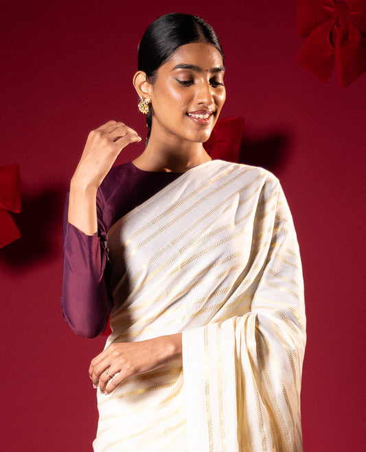 Borderless cream and maroon horizontal zari muthu striped Kerala cotton saree, self-pallu with tassels and a matching blouse