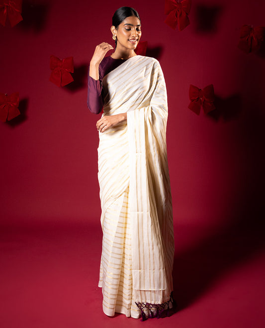 Borderless cream and maroon horizontal zari muthu striped Kerala cotton saree, self-pallu with tassels and a matching blouse