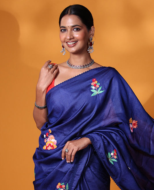 Borderless ink blue base tussar saree with kaleidoscopic-colored thread floral embroidery motifs