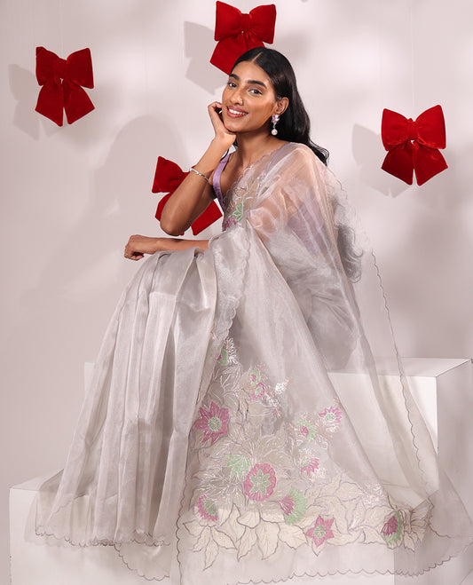 Scintillating grey floral embroidered with golden outlined organza saree, scallop border, and floral embroidered pallu