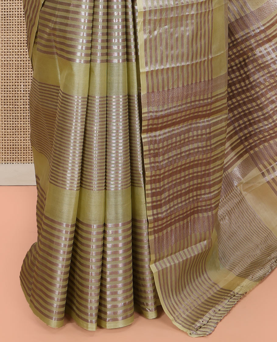 Green Tussar Silk Saree, Highlighted by Horizontal Zari Stripes Running All Over Its Body, Highlighted by Zari Striped Border, Zari Gleamed up Pallu, and Paired with a Matching Blouse