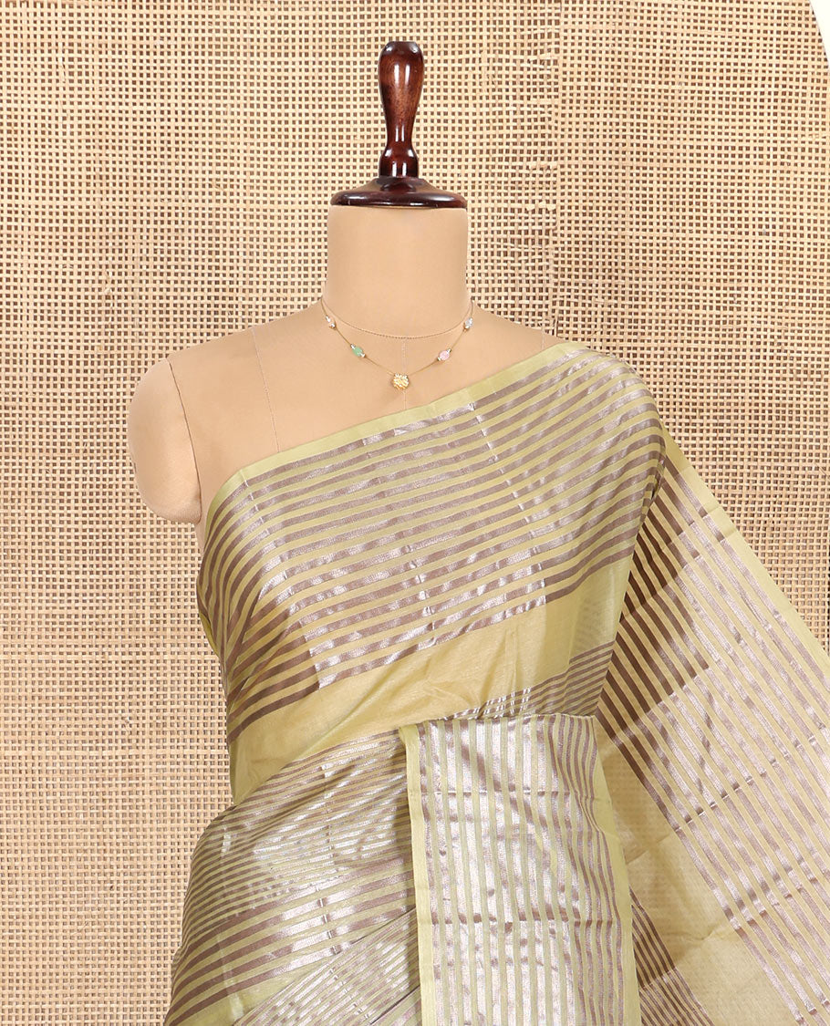 Green Tussar Silk Saree, Highlighted by Horizontal Zari Stripes Running All Over Its Body, Highlighted by Zari Striped Border, Zari Gleamed up Pallu, and Paired with a Matching Blouse