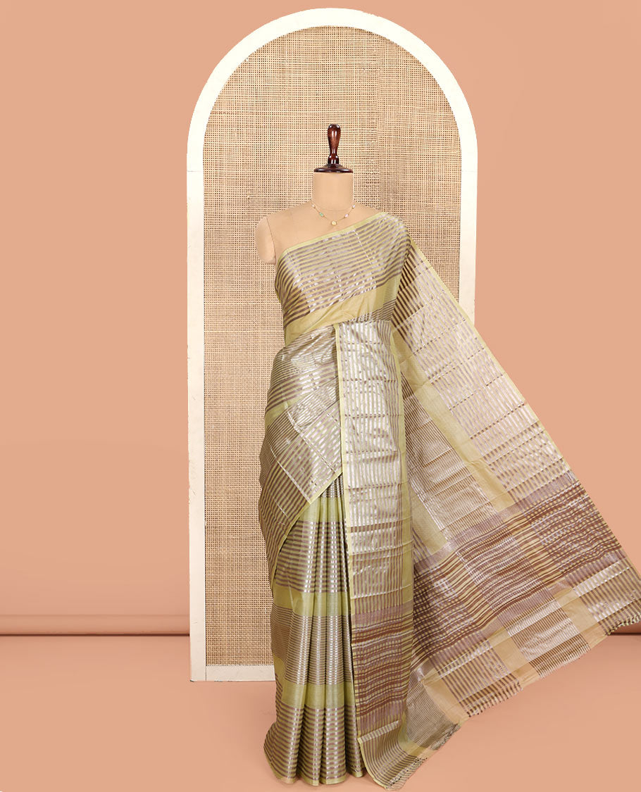 Green Tussar Silk Saree, Highlighted by Horizontal Zari Stripes Running All Over Its Body, Highlighted by Zari Striped Border, Zari Gleamed up Pallu, and Paired with a Matching Blouse