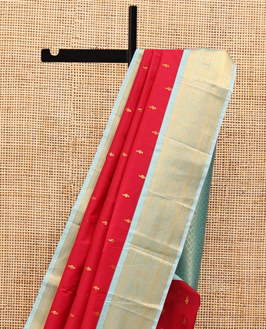 Red Orange Budget Silk Saree, Richly Detailed with Zari Buttas On Its Body, Complemented By a Contrast Traditional Zari Border of Paisley Designs, Intricately Designed Pallu, and Paired with a Contrast Blouse