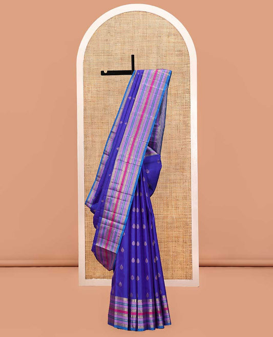 Violet and Mayil Blue Vasundhara Silk Saree, Subtly Sparkled with Zari Buttas All Over Its Body, Highlighted by Self-Border of Thilakam Mokku, Rudraksham, Muthu, and Mayil Kann Designs, Diagonally Striped Pallu, and Paired with a Matching Blouse
