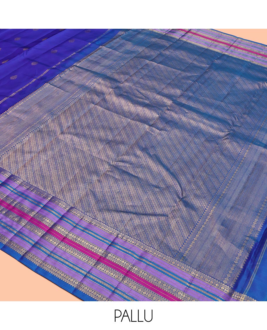 Violet and Mayil Blue Vasundhara Silk Saree, Subtly Sparkled with Zari Buttas All Over Its Body, Highlighted by Self-Border of Thilakam Mokku, Rudraksham, Muthu, and Mayil Kann Designs, Diagonally Striped Pallu, and Paired with a Matching Blouse